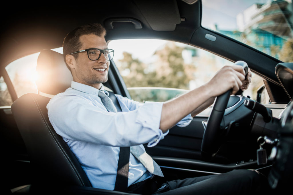 Businessman behind the wheel wearing glasses for driving Essilor Pro-Drive